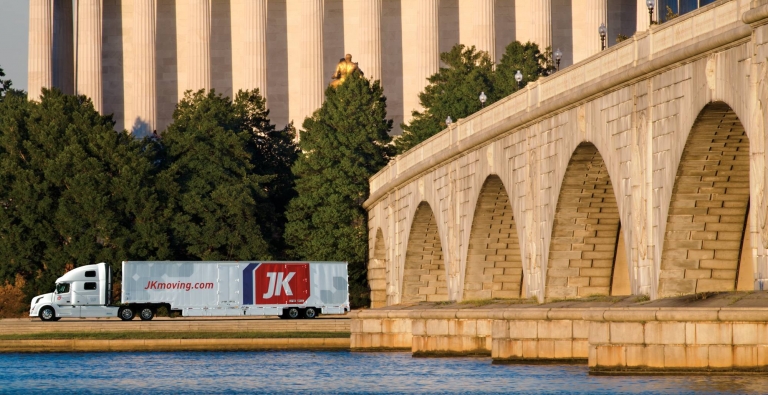 JK Moving truck driving past the Lincoln Memorial