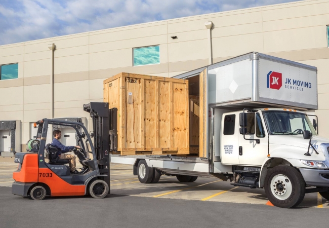 A JK Moving professional loading a truck
