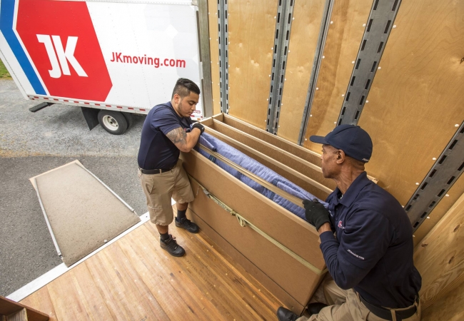 JK Moving professionals loading furniture
