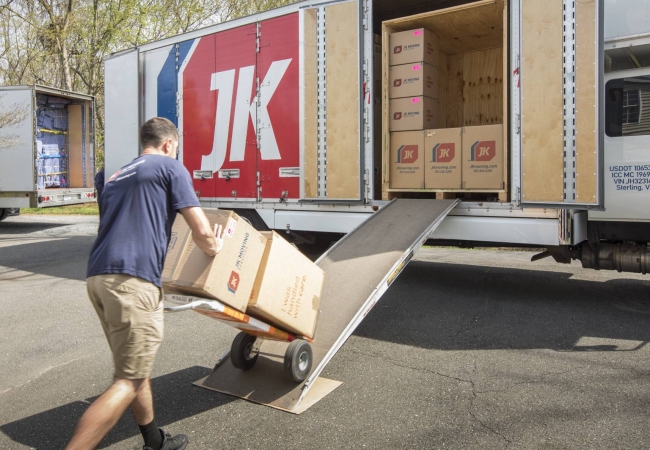 Movers loading a dolly onto a truck