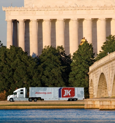 JK Moving truck driving past the Lincoln Memorial