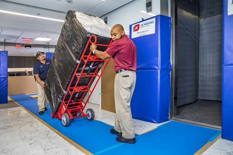 A team of JK employees moving IT equipment