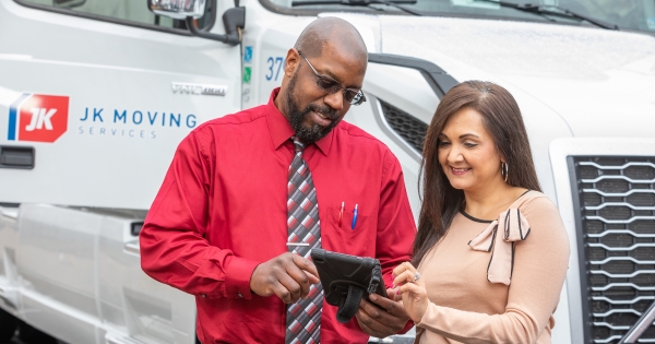 A JK Moving coordinator speaks with a client about her move