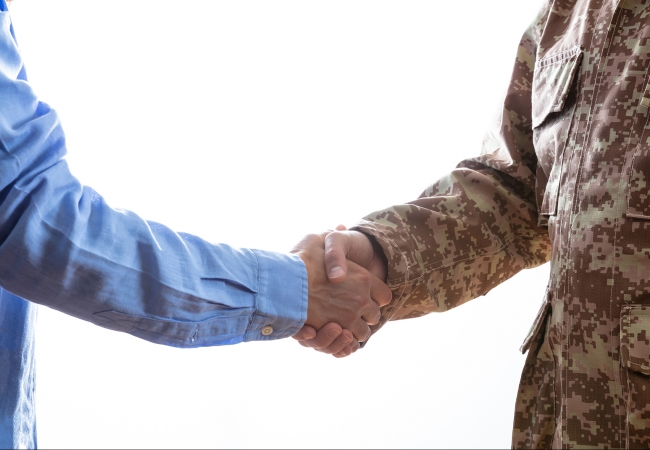 Military and civilian shaking hands