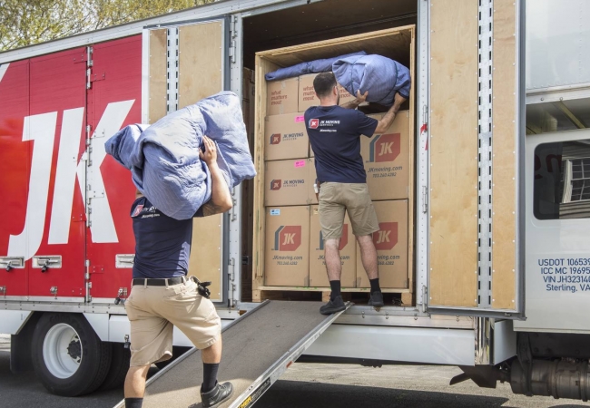 JK Moving professionals load a moving truck