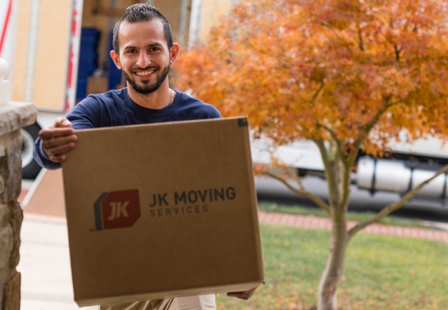 Experienced mover expertly handling a box during a seamless home relocation.