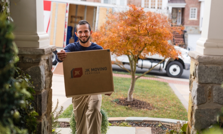 Experienced mover expertly handling a box during a seamless home relocation.