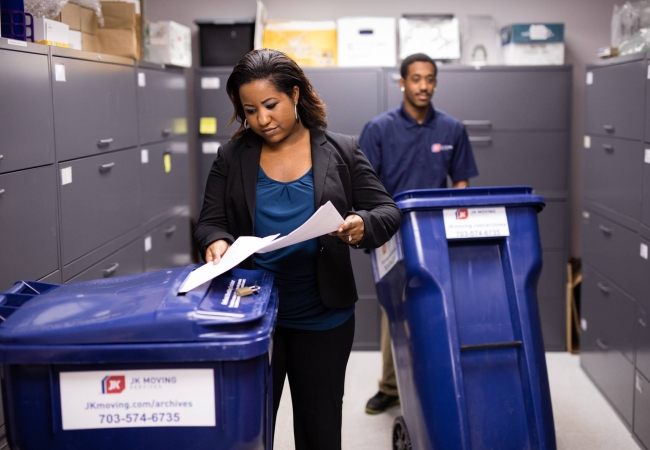 A team of office movers shredding documents