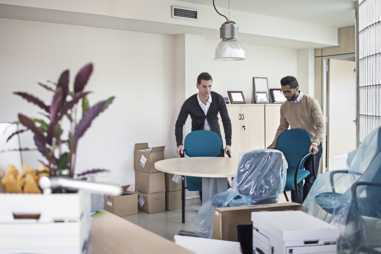 Young professionals preparing for downsizing their office