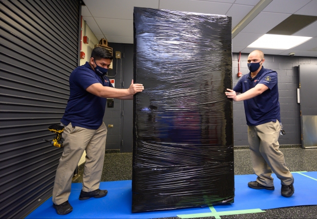 Team Members pushing Server Rack