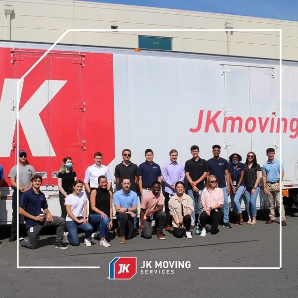 JK Moving Services Team posing in front of Tractor Trailer