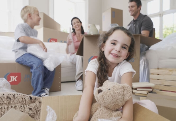 A family unpacking boxes in their new home, JK your trusted moving company