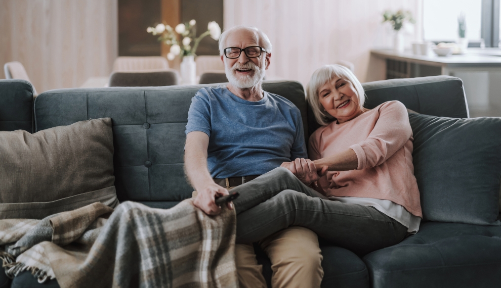 Elderly couple savoring quality time in the comfort of their home.