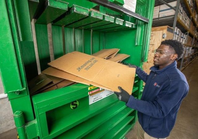 JK Moving employee recycling cardboard during a decommissioning project
