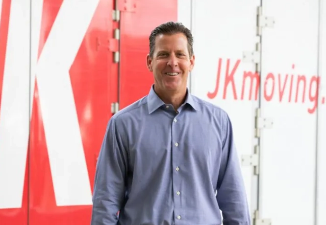 JK Moving CEO Chuck Kuhn standing in front of JK truck