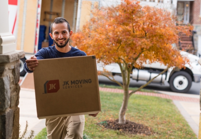 Experienced mover expertly handling a box during a seamless home relocation.