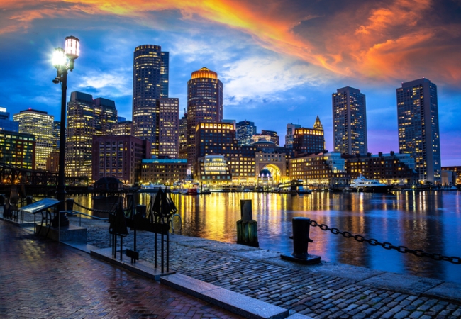 Panoramic view of Boston cityscape at Fan Pier Park at night, USA