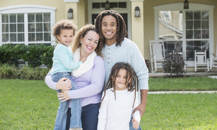 Family in front of 4-bedroom home