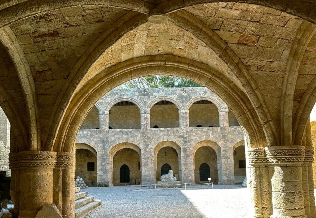 Historic archway in Rhodes’ Old Town, symbolizing the island’s blend of medieval charm and relaxed living
