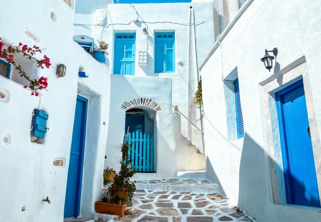 Iconic white houses and blue domes overlooking the Aegean Sea in Santorini, a dream destination for international movers.