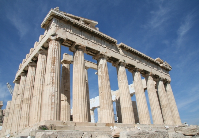 The Parthenon in Athens under a clear blue sky, highlighting Greece’s ancient history and modern city life