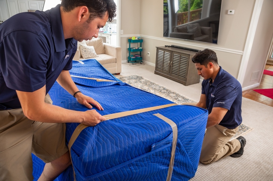 Prepare furniture for moving - wrapping sofa