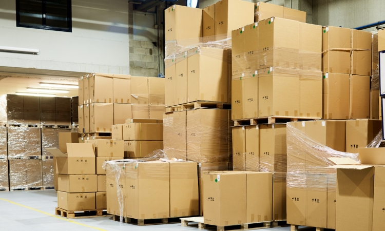 Stacks of palletized cardboard boxes in a warehouse highlighting business storage capacity challenges