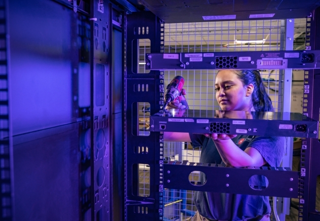 IT technician handling server equipment during a workplace technology relocation