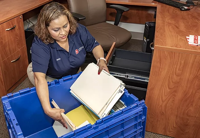 Moving professional packing office documents into a reusable moving crate