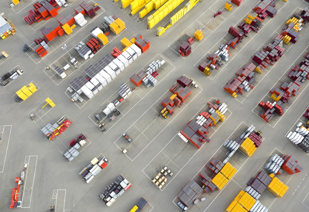 Aerial view of an industrial storage yard with organized equipment and materials