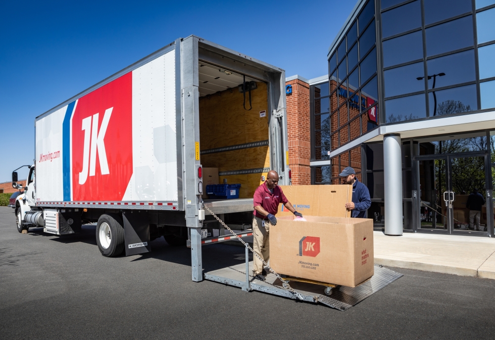 JK Moving crew loading office boxes onto a moving truck during a commercial office relocation